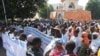 People holding banners take part in a protest called by the Coordination of Patriotic Organizations in Mali (COPAM) against a foreign military intervention in Mali to reclaim the Islamist-controlled north, September 28, 2012.