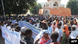 People holding banners take part in a protest called by the Coordination of Patriotic Organizations in Mali (COPAM) against a foreign military intervention in Mali to reclaim the Islamist-controlled north, September 28, 2012.