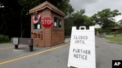 A sign sits at the entrance of Cheesequake State Park, which remains closed due to the New Jersey government shutdown, Saturday, July 1, 2017, in Matawan, N.J.