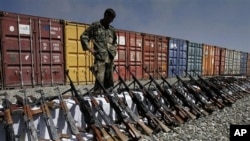 An Afghan policeman looks at weapons confiscated from private security companies, in Kabul, Afghanistan (File Photo - 05 Oct 2010)
