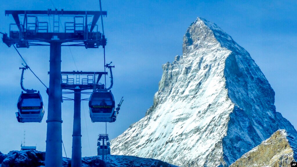 FILE - Gondolas go up next to the Matterhorn in Zermatt, Switzerland, Dec.3, 2020. 