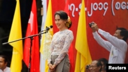 FILE - Myanmar's pro-democracy leader Aung San Suu Kyi delivers a speech at a rally in Boseinman Stadium in Yangon.