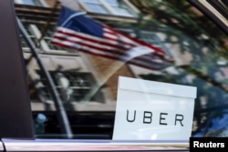 An Uber sign is seen in a car in New York, June 30, 2015.