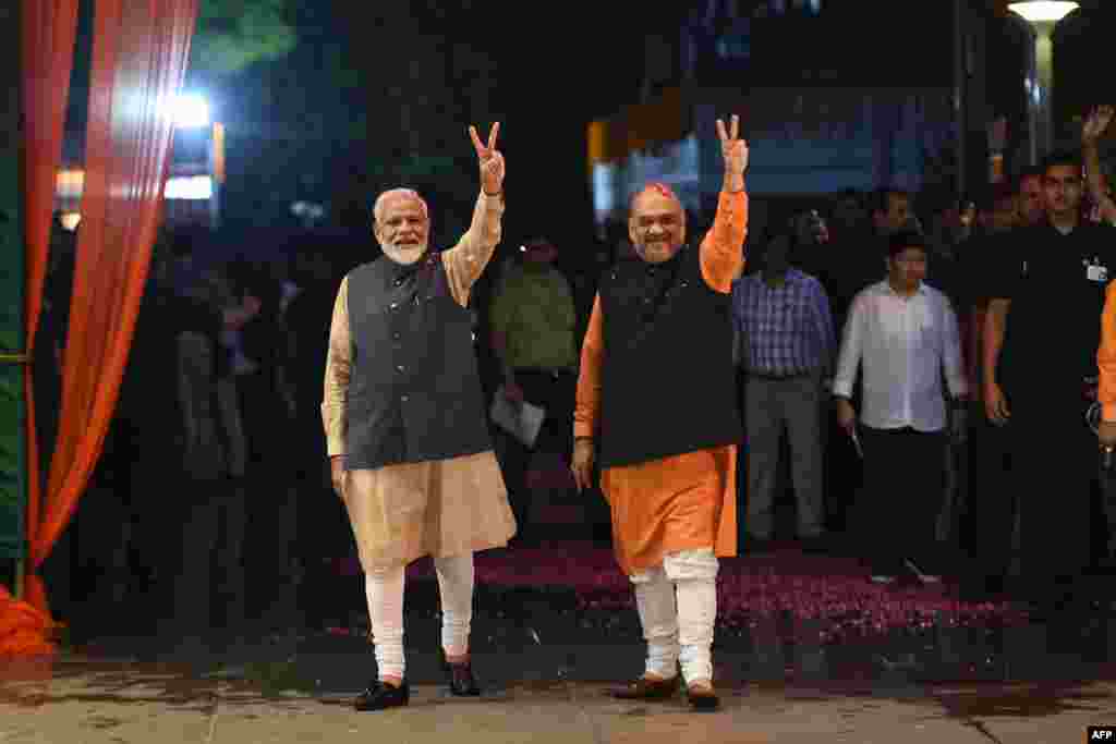 Indian Prime Minister Narendra Modi (L) and president of the ruling Bharatiya Janata Party (BJP) Amit Shah celebrate victory in India&#39;s general elections, in New Delhi.