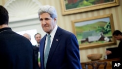 Secretary of State John Kerry is seen in the Oval Office of the White House in Washington, Monday, March 17, 2014, during President Barack Obama's meeting with Palestinian President Mahmoud Abbas.