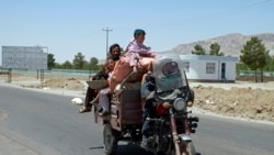 An Afghan family flees fighting as Afghan security personnel took back control of parts of the city of Herat following fighting between Taliban and Afghan security forces, on the outskirts of Herat, west of Kabul, Afghanistan. (AP)