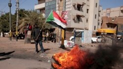 People burn tires during a demonstration against the killing of dozens by Sudanese security forces since the Oct. 25, 2021 military takeover, in Khartoum, Sudan, Jan. 20, 2022.