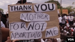 A protester holds a placard during anti-abortion protests in Lilongwe, Malawi, Dec. 6, 2016. (L. Masina/VOA)