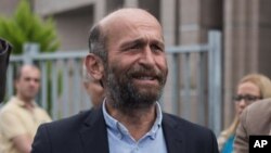 Erdem Gul, Ankara Bureau Chief of Cumhuriyet newspaper, speaks outside city's main courthouse in Istanbul, Sept. 21, 2016.