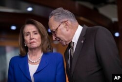 FILE - House Minority Leader Nancy Pelosi, D-Calif., left, and Senate Minority Leader Chuck Schumer, D-N.Y., confer as they call for action from President Donald Trump.