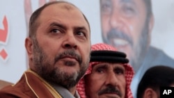 FILE - Deputy Leader of the Jordanian Muslim Brotherhood, Zaki Bani Ersheid, left, speaks to supporters after his release from a Jordanian prison, in Amman, Jordan, Jan, 4, 2016. 