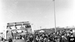 An armed soldier stands on duty at Selma, Ala., March 21, 1965, as Martin Luther King, Jr. and his civil rights marchers head for Montgomery, the state's capitol, on a five day, 50 mile walk to protest voting laws. The soldiers were called out by Preside