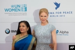 FILE - Actress Nicole Kidman, right, and the acting head of U.N. Women Lakshmi Puri attend the Cinema For Peace fundraising dinner in Berlin, Germany, July 12, 2013.