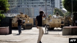 Trucks and APC's of Egyptian riot police are parked outside the Egyptian Museum near the main access to Egypt's landmark Tahrir square on August 20, 2013 in Cairo, Egypt. 