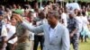 Incumbent President Faure Gnassingbe, who is running for a third term, waves to a crowd at a campaign rally in Tado, Togo, April 13, 2015.