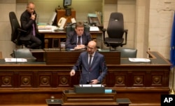 Belgian Prime Minister Charles Michel, center, addresses Belgium's parliament announcing security measures after the recent deadly Paris attacks, in Brussels, Nov. 19, 2015.