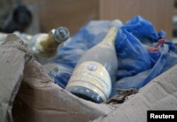 A dusty champagne bottle from an edition commemorating the day former Gambian President Yahya Jammeh came to power is seen in his estate in Kanilai, Gambia, July 1, 2017.