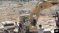 Just Vision produces documentaries, such as 'Budrus,' which highlights the nonviolent efforts of both Palestinians and Israelis to protest Israel's plan to destroy a Palestinian village by building a separation wall.