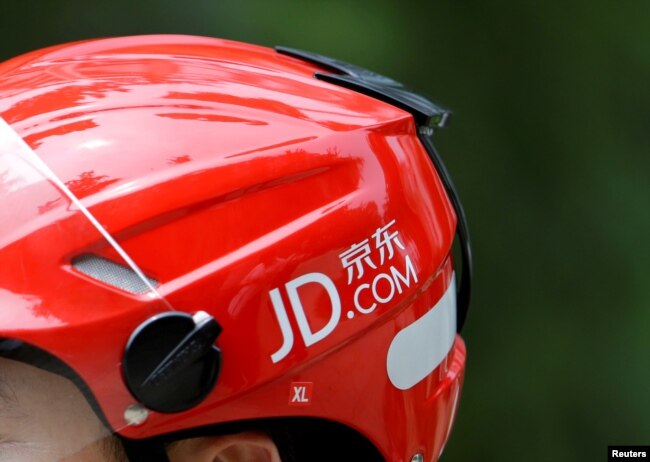 FILE - A logo of JD.com is seen on a helmet of a delivery man in Beijing, June 16, 2014.