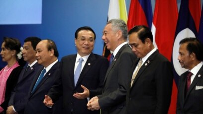 Thủ tướng Trung Quốc Lý Khắc Cường trò chuyện với Thủ tướng Singapore Lý Hiển Long khi các nhà lãnh đạo ASEAN chụp hình chung tại Hội nghị Thượng đỉnh ASEAN-Trung Quốc ở Singapore, ngày 14 tháng 11, 2018. 