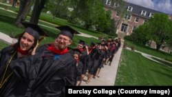 FILE: Barclay College graduates Taylor Mabry and Ryan Kucharek walk across campus to commencement ceremonies. Haviland, Kansas. May 2019