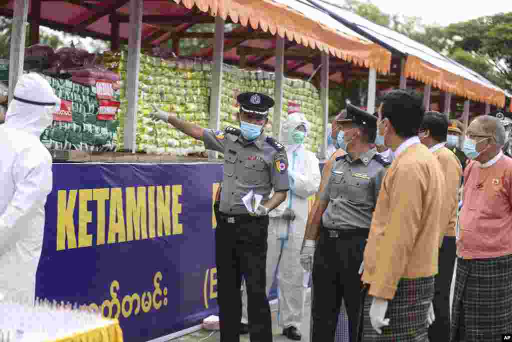 ရန်ကုန်တိုင်းဝန်ကြီးချုပ် ဦးဖြိုးမင်းသိန်းကို တရားမဝင်မူးယစ်ဆေးဝါးများကို&nbsp;ပြသရှင်းပြနေတဲ့ ရဲအရာရှိတဦး။ (ဇွန် ၂၆၊ ၂၀၂၀)