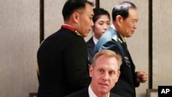 Acting U.S. Secretary of Defense Patrick Shanahan, center, and Chinese Minister of National Defense Gen. Wei Fenghe, right, attend a ministerial luncheon on the sidelines of the 18th International Institute for Strategic Studies (IISS) Shangri-la Dialogue