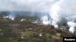 Molten rock flows and burst to the surface, threatening homes in a rural area in this still image from an aerial video taken from a Hawaii Army National Guard a week after the eruption of the Kilauea volcano, in Pahoa, Hawaii, May 10, 2018.