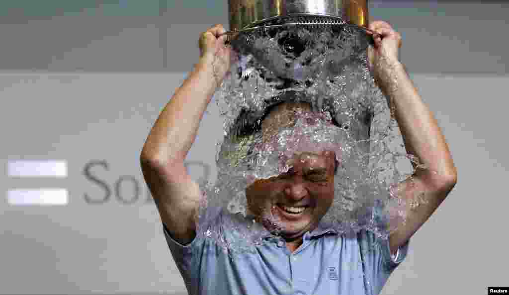 SoftBank Corp. Chief Executive Masayoshi Son dumps a bucket of ice water onto himself as he takes part in the ALS ice bucket challenge at the company headquarters in Tokyo, Japan.