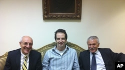 In a photo made available by the office of Israeli Knesset Member Israel Hasson October 26, 2011, shows Ilan Grapel (center), a U.S.-Israeli citizen arrested in Egypt between Israel Hasson, right, and lawyer Yitzhak Molcho, left, in Cairo, Egypt.
