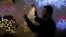 A Palestinian man arranges decoration lights in a shop in preparation for Christmas season, amid the coronavirus disease (COVID-19) outbreak, in Beit Sahour in the Israeli-occupied West Bank November 26, 2020. (REUTERS/Mussa Qawasma)