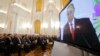 Russian President Vladimir Putin is seen on a screen during his annual state of the nation address at the Kremlin in Moscow, Russia, December 1, 2016. 