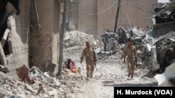 Relatives of IS are some of the last to leave the ruins of Old Mosul. It is unknown if they, like other civilians were forced to stay with IS or if they stayed to support fighters on July 13, 2017 in Mosul, Iraq. (H.Murdock/VOA)