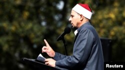 Imam Gamal Fouda leads a Friday prayer at Hagley Park outside Al Noor Mosque in Christchurch, New Zealand, March 22, 2019.