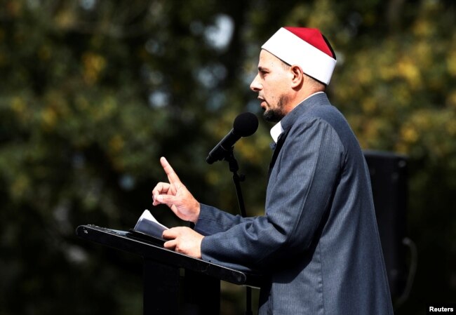 Imam Gamal Fouda leads a Friday prayer at Hagley Park outside al-Noor mosque in Christchurch, New Zealand, March 22, 2019.