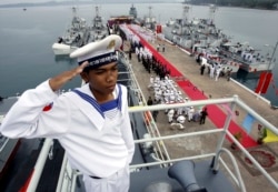 FILE- A Cambodian Navy sailor salutes on a Chinese naval patrol boat during a handover ceremony at a Cambodian naval base at Ream in Sihanoukville province, southwest of Phnom Penh, November 7, 2007.