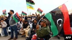 FILE - Libyan protesters take part in a rally in support of "Fajr Libya" (Libya Dawn), a mainly Islamist alliance, in Tripoli's central Martyr's Square, Feb. 13, 2015.