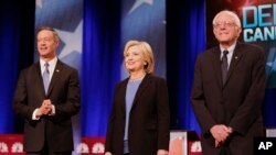 From left, Democratic presidential candidates Martin O'Malley, Hillary Clinton and Bernie Sanders stand together before the start of the NBC, YouTube Democratic presidential debate at the Gaillard Center in Charleston, S.C., Jan. 17, 2016.