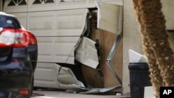 Cửa nhà để xe của Enrique Marquez bị hỏng sau một cuộc tấn công của FBI gần đây, ngày 09/12/2015, ở Riverside, California.
