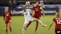 France midfielder Camille Abily, left, battles for the ball against United States midfielder Carli Lloyd, right, during the first half of a SheBelieves Cup women's soccer match, March 7, 2017, in Washington.