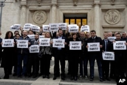 Northern League's leader Matteo Salvini, center, stands with party lawmakers holding a placard reading in Italian "Vote Now" outside the Lower Chamber in Rome, Dec. 6, 2016.