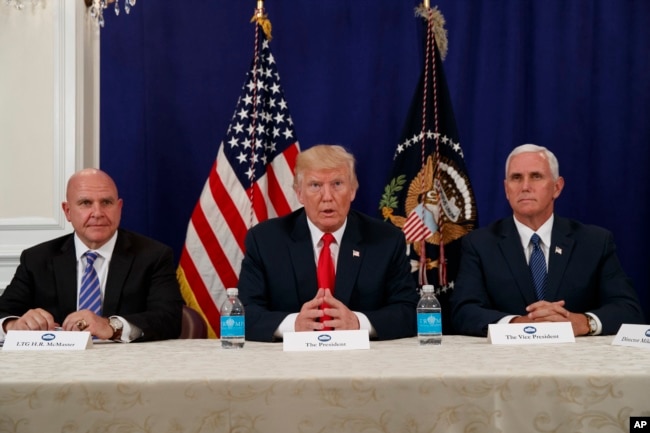 President Donald Trump, flanked by National Security Advisor H.R. McMaster, left, and Vice President Mike Pence, speaks to reporters after a security briefing at Trump National Golf Club in Bedminster, N.J., Aug. 10, 2017.