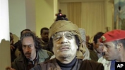 Moammar Gadhafi arrives at a hotel in Tripoli to give television interviews, March 8, 2011
