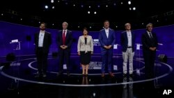 Chilean presidential candidates, from left, Gabriel Boric, Jose Antonio Kast, Yasna Provoste, Sebastián Sichel, Eduardo Artes, and Marco Henriquez-Ominami, pose for a photo prior to the presidential debate in Santiago, Chile, Nov. 15, 2021. (AP Photo/Esteban Felix, Pool)