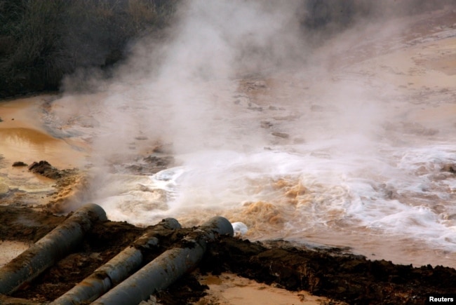 FILE PHOTO: Polluted water flows out of pipes from a rare earth factory near Baotou, a city in China's Inner Mongolia Autonomous Region in this picture from 2010. (Reuters)ure.