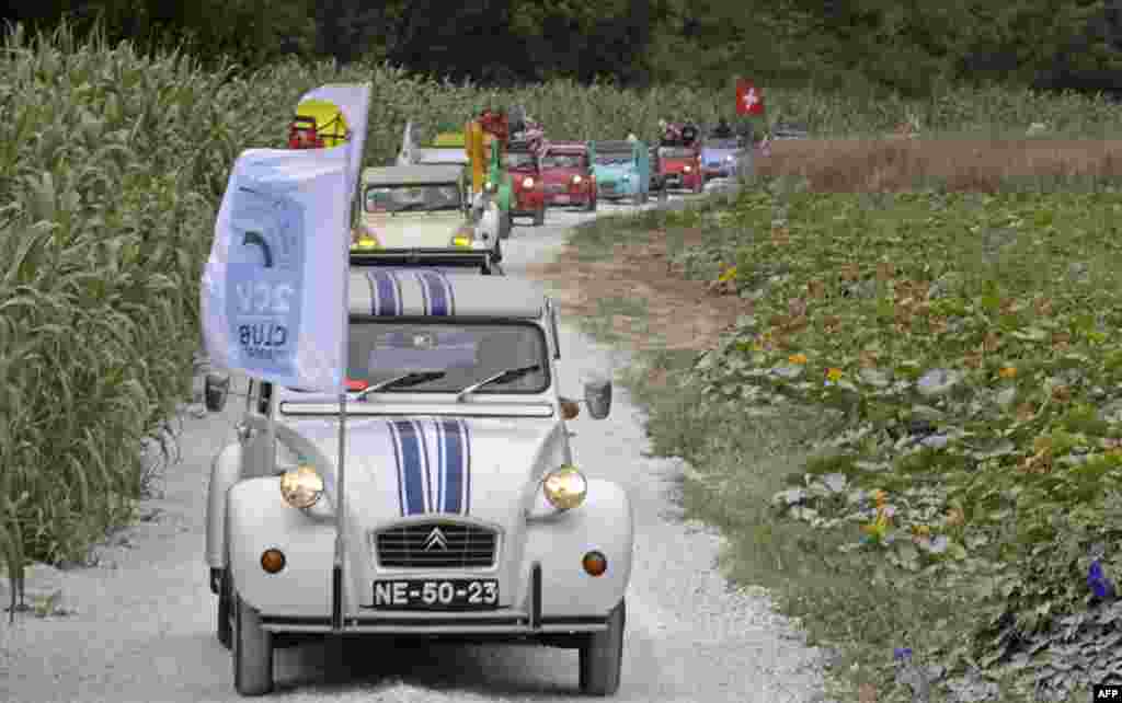 Cars parade through the country side between Ericeira and Mafra during the World 2017 2CV Meeting, Portugal.