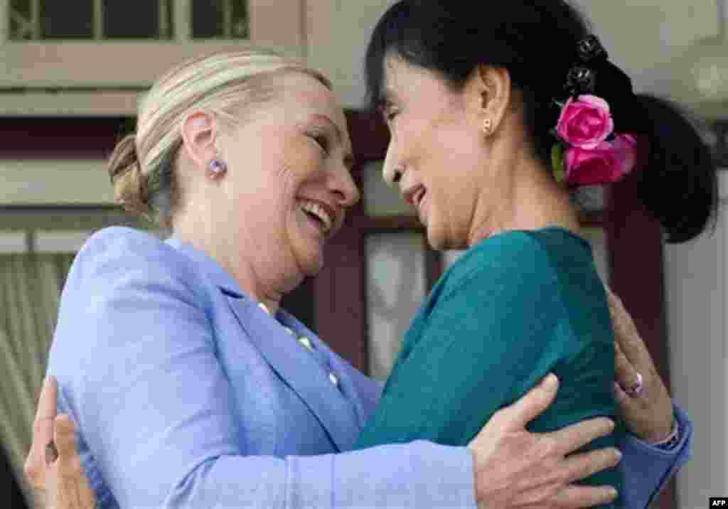 Myanmar's pro-democracy opposition leader Aung San Suu Kyi, right, and U.S. Secretary of State Hillary Rodham Clinton embrace while speaking to the press after meetings at Suu Kyi's residence in Yangon, Myanmar Friday, Dec. 2, 2011. (AP Photo/Saul Loeb, P