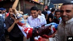 Egyptians evacuate a wounded man during clashes between security forces and supporters of Egypt's ousted President Morsi, Aug. 16, 2013.