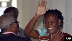 Ivory Coast's former first lady Simone Gbagbo waves as she arrives at the Court of Justice in Abidjan, Feb. 23, 2015