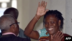 Ivory Coast's former first lady Simone Gbagbo waves as she arrives at the Court of Justice in Abidjan, Feb. 23, 2015